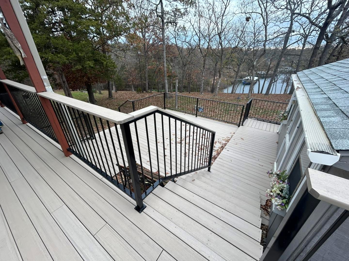 White composite lake deck with black aluminum picket railing